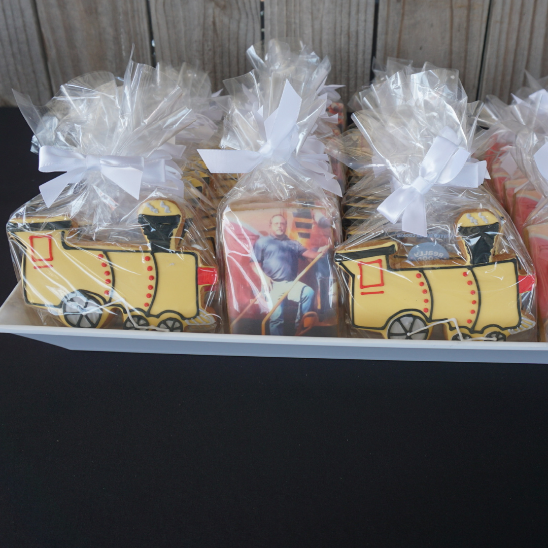 A photo of Really Good Cookie's train Custom Cookies and photo cookies for a retirement