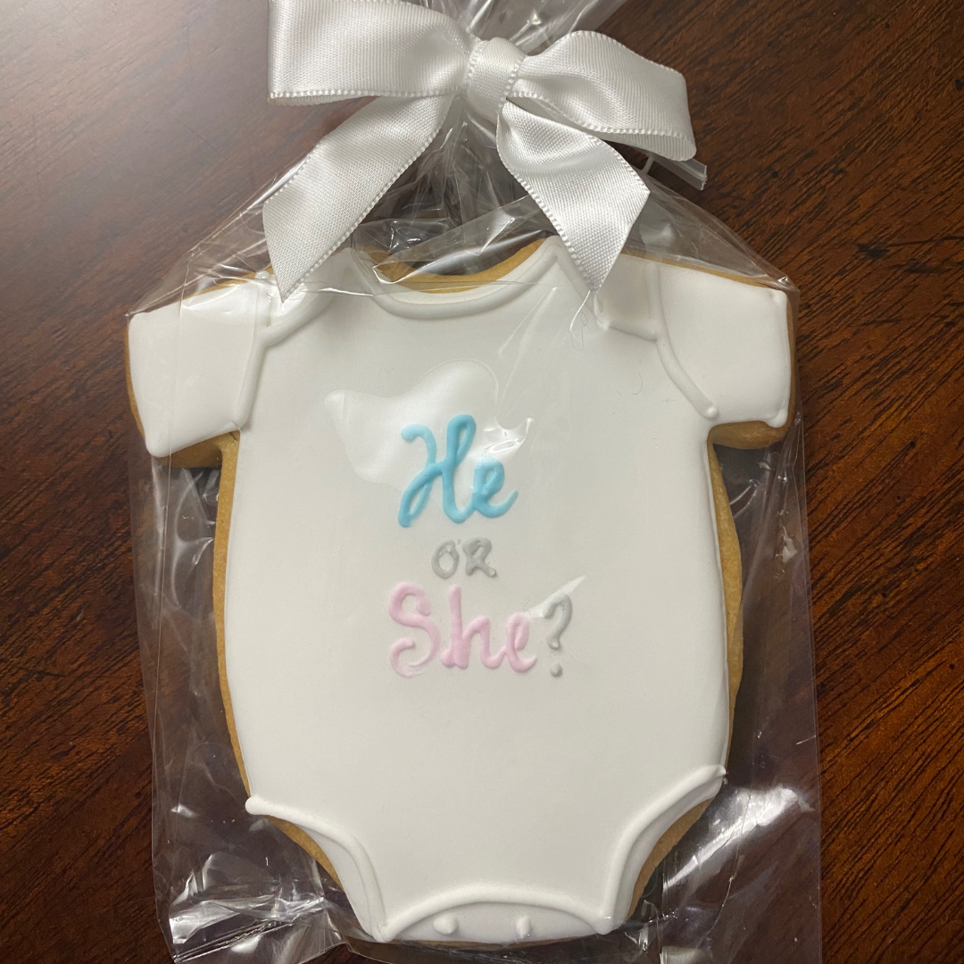 Image of beautifully decorated gender reveal cookies from Really Good Cookies, featuring subtle pink and blue designs with question marks, ready to delight recipients with the joyful news.